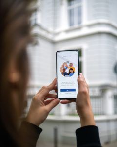 teams screen person holding white smartphone